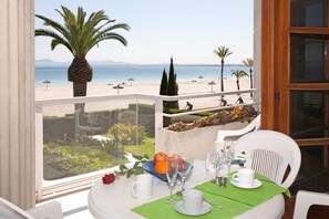 Ein Tisch für zwei mit Blick auf einen Strand und Palmen.