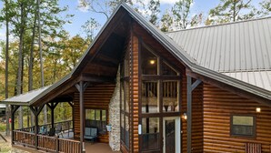 A log cabin with a porch, stone foundation, and a metal roof. - Honey Hole Cabin is located on the Carson Creek Rd. Minutes to the Lake (Broken Bow)