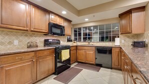 A kitchen with wooden cabinets, a microwave, stove, oven, and dishwasher. - ***3200 Sq Ft 5 Bed 4 Bath 1 Story Private Pool/Spa W/ Casita (Las Vegas)
