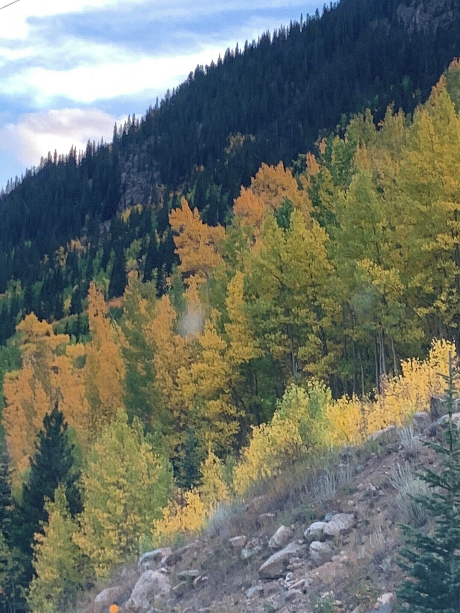 A mountainous landscape with autumn-colored trees.