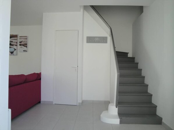 A staircase with a handrail leading to a landing.