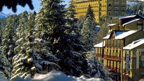 A snow-covered building with a prominent hotel sign, surrounded by snow-laden trees. - T2 apartment in FONT ROMEU. Label 2 Clévacances. Exceptional panorama (Font-Romeu-Odeillo-Via)