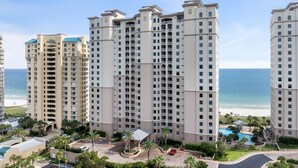 A high-rise hotel with multiple balconies, a pool area, and a view of the beach. - Indigo 504E BeachFront!Bonus Den,Best View&Amenities HUGE Pool!HotTub Pickleball (Pensacola)