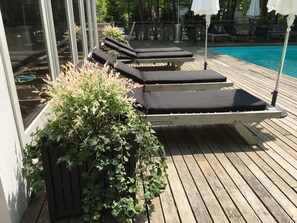 A wooden deck with lounge chairs and a pool. - East Hampton Home / September available (East Hampton)