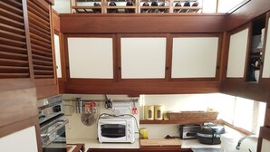 A compact kitchen with a microwave, toaster, and washing machine.