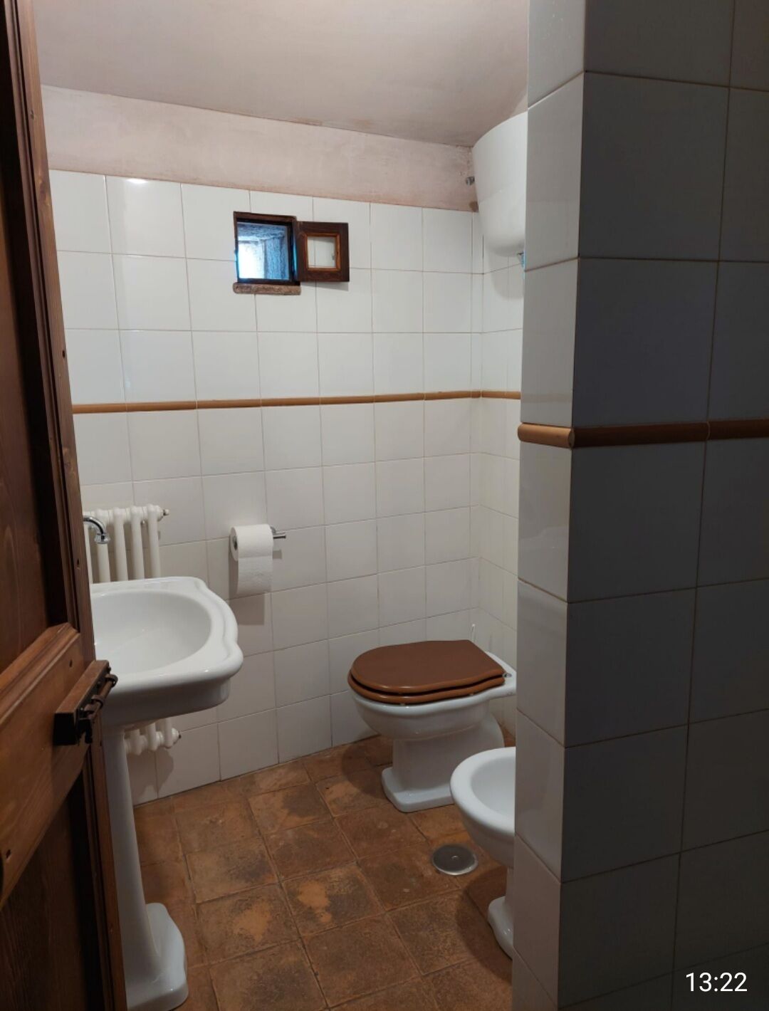 A small bathroom with a toilet, bidet, and sink.