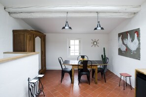A dining area with a wooden table, black chairs, and two pendant lights. - Arles city center near the Bullring (Arles)