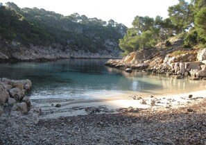 Escape to a serene coastal haven with a tranquil pebble beach and breathtaking bay views.
