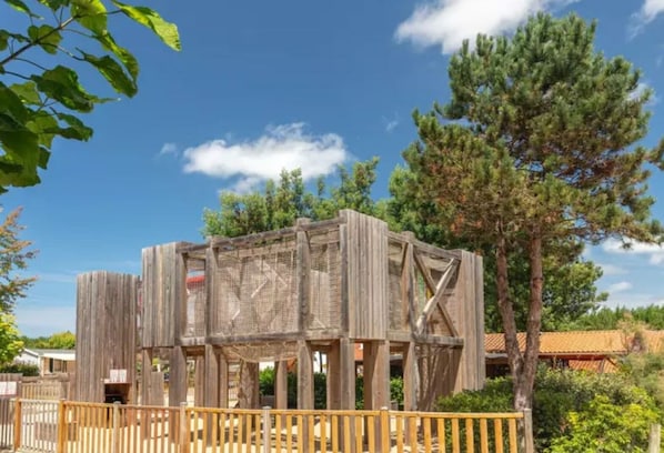A rustic wooden structure with a wooden fence in front.