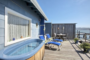 Private bayfront deck with hot tub and lounge chairs