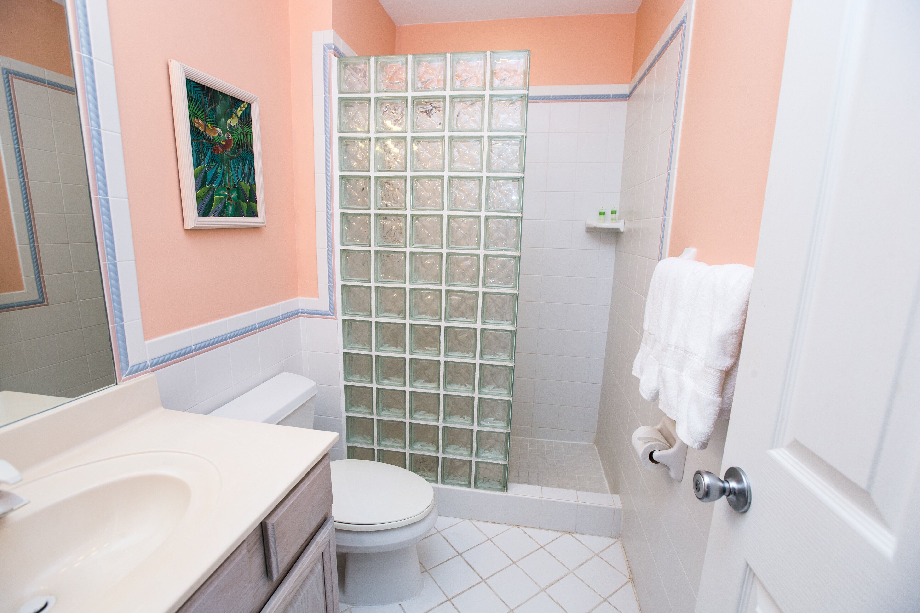 A bathroom with a toilet, sink, and shower.