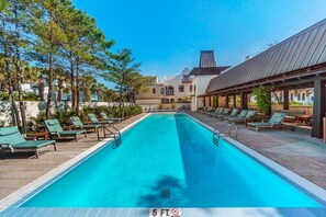 Relax by the rectangular pool surrounded by lounge chairs and a low wall, offering a tranquil retreat.