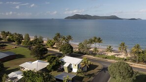 A coastal residential area with houses, a road, and a beach.