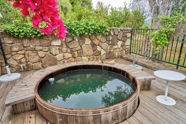 old redwood hot tub off front patio over looking valley, pink moment, orchard, and clay tennis court
