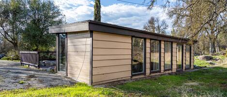 A modern, single-story building with large windows, a flat roof, and a concrete foundation.