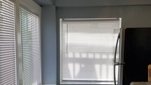 A kitchen with a white countertop, a refrigerator, and a window with blinds. - A Stone Throw to Beach and Convention Center and Two Blocks from the Crest!! (Wildwood)