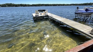 A clear lake with a wooden dock extending into the water. - Eagle Lake Kalamazoo, Mattawan - Lake Livin' (Mattawan)