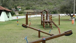 A playground with a seesaw and climbing structures.