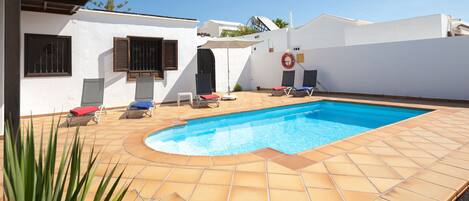 A heated pool, pool umbrellas, pool loungers