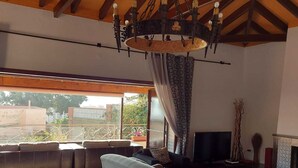 A spacious living room with a large sofa, a television, and a fireplace. - Villa with private pool in Torremolinos  (Torremolinos)