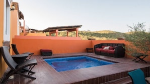 A rooftop pool area with a hot tub, wicker chairs, and a red sofa. - Beautiful house in San Carlos (SAN CARLOS)