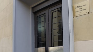 A building entrance with a metal door and a small set of steps leading up to it. - NEW SWEET FLORENCE (at T2 Belfiore) (Firenze)