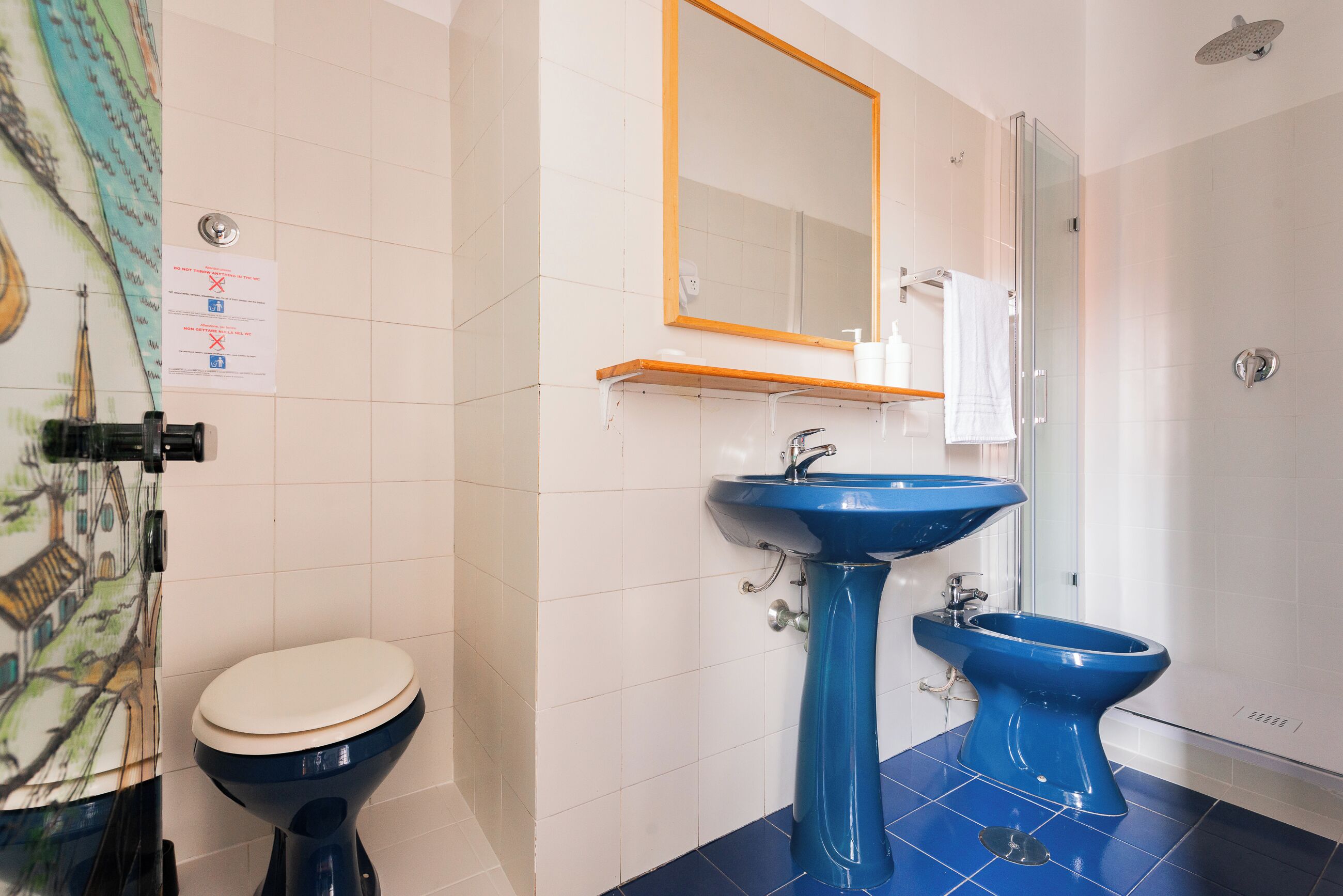 Een badkamer met een toilet, een wastafel en een douchetoilet.