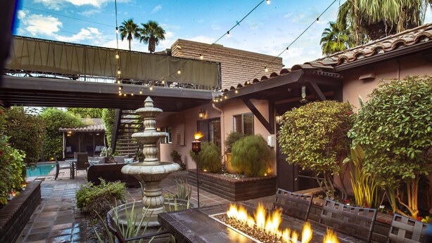 A patio area with a fire feature, outdoor seating, a fountain, and a pool. - Hotel California - A Town & Desert Boutique Hotel (Palm Springs)