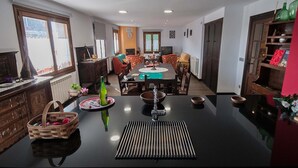 A dining area with a long table, chairs, and a buffet setup. - RURAL HOUSE IN SIERRA DE ARALAR, 4O KM FROM SAN SEBASTIAN-30 PAMPLONA 12 PEOPLE (Baráibar)