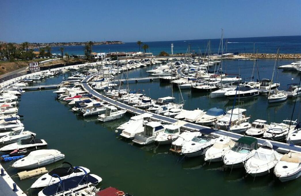A marina with numerous boats docked in a circular layout.