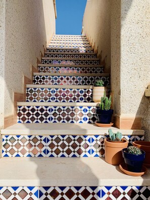 A staircase with colorful patterned tiles leading up to a door. - Beautiful apartment 2ch 2sdb Las Ramblas Golf Orihuela (villacosta)