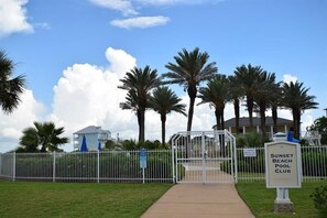 Enjoy a serene atmosphere surrounded by palm trees and a well-maintained lawn.