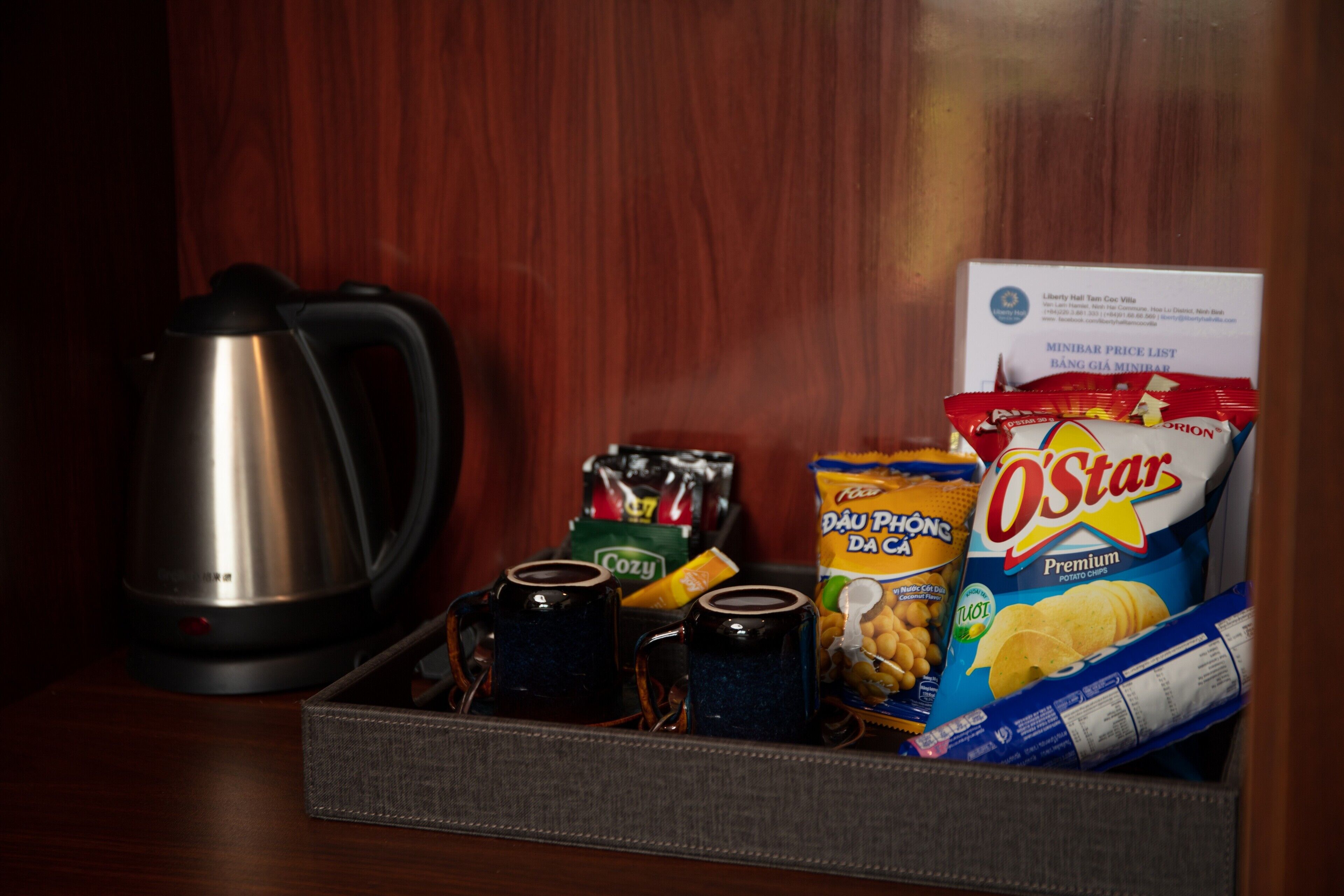 A tray with snacks, a kettle, and a price list.