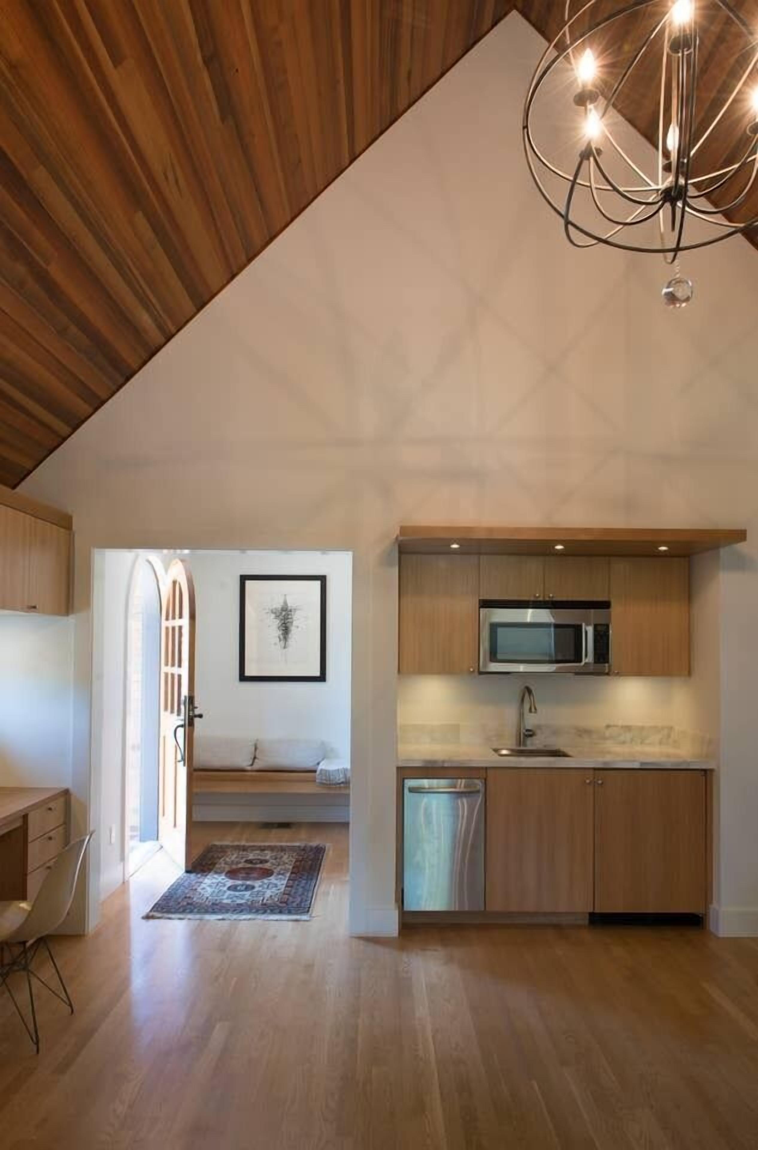 A modern kitchen with wooden cabinets, a microwave, and a dishwasher.