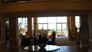 A lobby with a view of the city, a staircase, and a buffet sign. - Grand Pacific Palisades Resort - 2 Bedroom/2 Bath - LAST MINUTE SPECIAL!!! (Carlsbad)