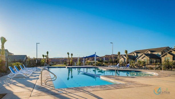 A swimming pool with lounge chairs, a blue canopy, and houses in the background. - Endless Adventures-Pool is Open! (Washington)