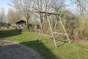 Relax in a serene park-like setting with a rustic wooden swing.
