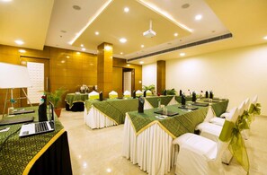 A conference room with tables set for a meeting, equipped with laptops and presentation equipment. - Hotel Kapish Smart (Jaipur)