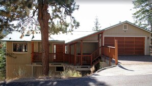 A two-story house with a covered porch and a garage.