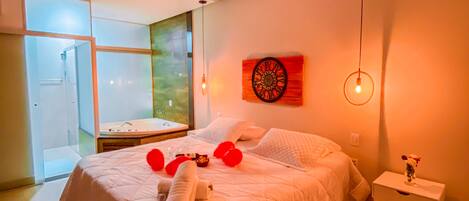 A modern bedroom with a large bed, a bedside table with a vase, and a window with a view.