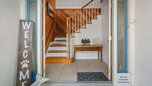 A staircase with wooden steps and white railings leading to an upper floor. - 4Bdm Waterfront Home w/ Heated Pool, Walk to Beach (Indian Rocks Beach)