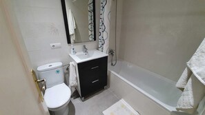 Bathtub, hair dryer, towels