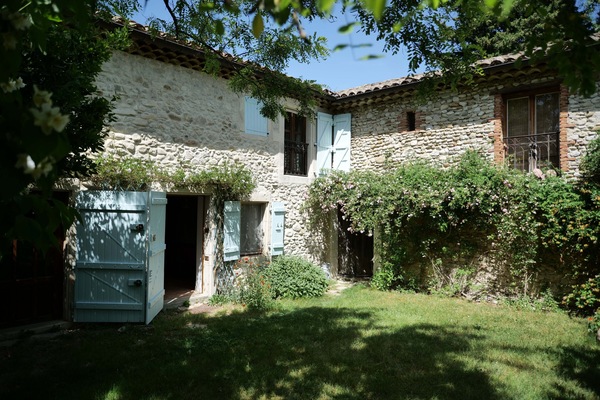 Courtyard and main house (blue doors and blinds). Front door into the kitchen.