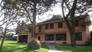 A two-story building with a paved driveway leading to a covered entrance.