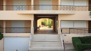 A building entrance with a sign reading "PRAIA VILLAGE" and a staircase leading to the entrance. - Fully licensed prestigious Algarve apartment for rental in Vilamoura (Quarteira, Vilamoura)