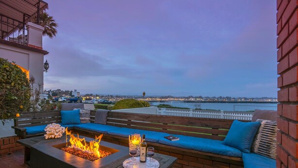 A rooftop terrace with a fire pit, seating area, and a view of the cityscape. - OCEANFRONT! BEST LOCATION! EXTRAORDINARY VIEWS! HOT TUB! FIRE PIT! (Santa Cruz)