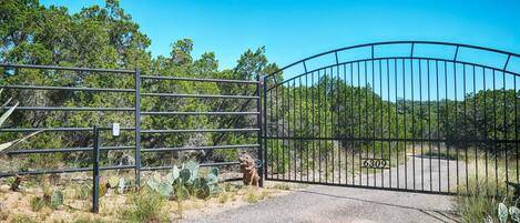 A gated entrance with a metal gate and a number 6309 sign.