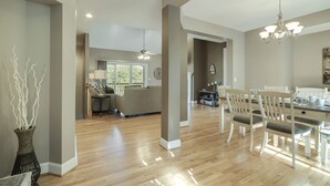A spacious living area with a dining table, chairs, and a chandelier. - • Reserve TOQUA COVES • Family Friendly • Lake Access • Two Decks • Sleeps 6+ (Loudon)