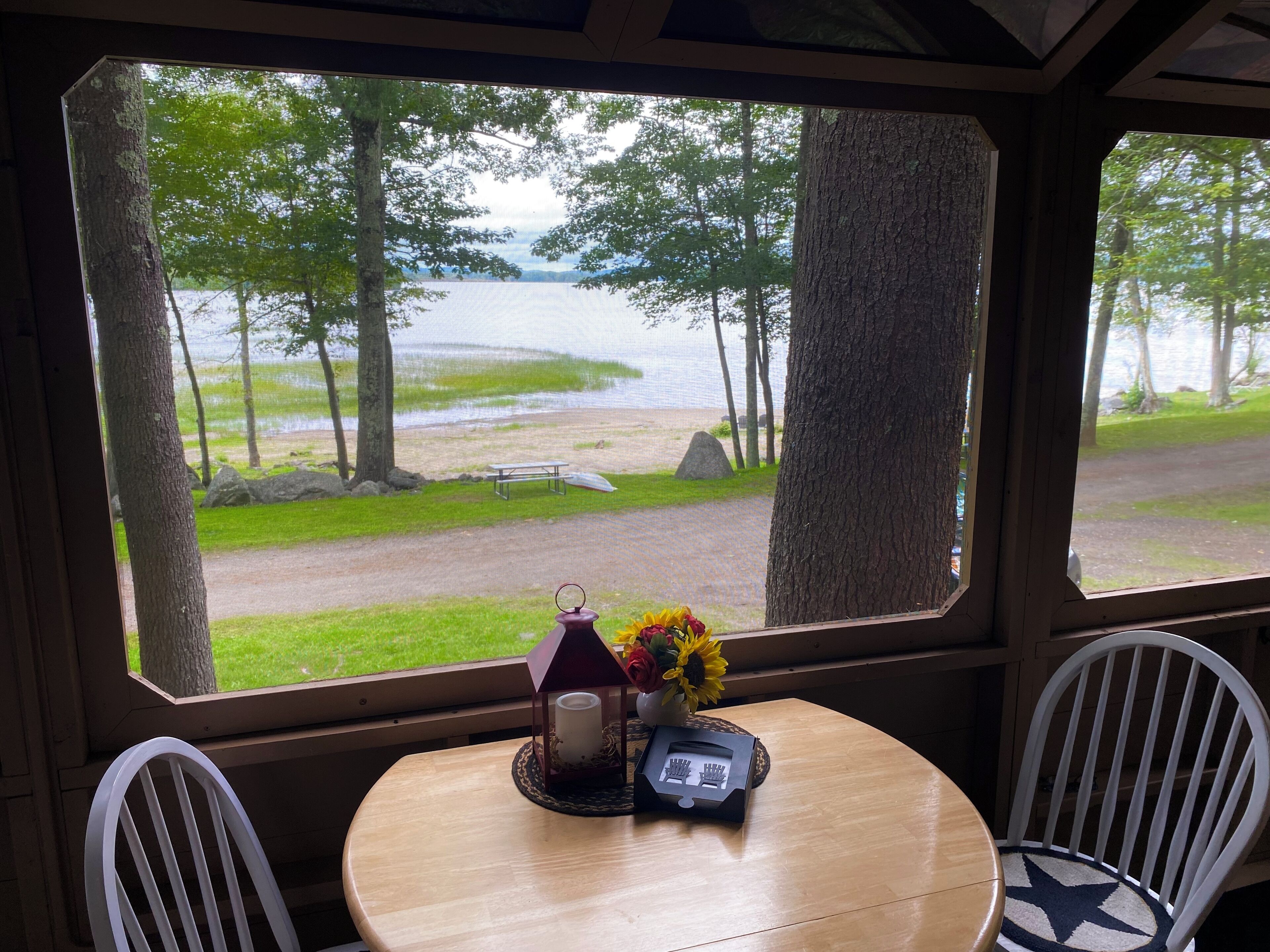 Porch dining table overlooks the lake and beach.