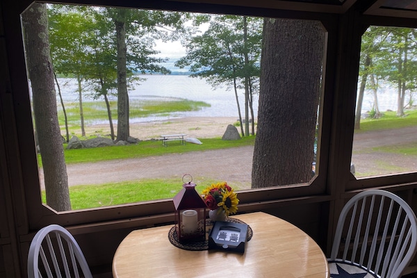 Porch dining table overlooks the lake and beach.